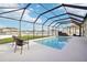 Backyard with view of screened-in pool and hot tub and fenced in yard at 5269 Red Coral Cir, Mount Dora, FL 32757