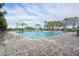 An expansive outdoor pool with lounge seating, mature landscaping, and well-maintained brick pavers offers residents a relaxing retreat at 5269 Red Coral Cir, Mount Dora, FL 32757