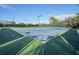 Active community tennis court with green and blue surface and well maintained court and fencing at 5269 Red Coral Cir, Mount Dora, FL 32757