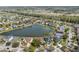 Aerial view of the neighborhood with homes surrounding a pond and a distant view of a highway at 5314 Adair Oak Dr, Orlando, FL 32829