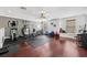 Spacious home gym featuring hardwood floors and a variety of fitness equipment at 5314 Adair Oak Dr, Orlando, FL 32829