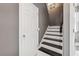 Stairwell featuring dark treads and white risers, leading to the upper level of the home at 5314 Adair Oak Dr, Orlando, FL 32829