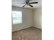 Bedroom showcasing neutral carpet, a ceiling fan, and a window to let in natural light at 5325 Curry Ford Rd # B201, Orlando, FL 32812