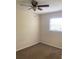 This bedroom features neutral carpet, a ceiling fan, and a window to let in natural light at 5325 Curry Ford Rd # B201, Orlando, FL 32812