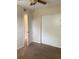 A cozy bedroom featuring neutral carpeting, ceiling fan, and a closet with sliding doors at 5325 Curry Ford Rd # B201, Orlando, FL 32812