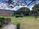 Lush green lawns and manicured bushes surrounding brick apartments, offering a tranquil outdoor space at 5325 Curry Ford Rd # B201, Orlando, FL 32812