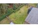 Aerial view of the backyard featuring manicured landscaping, a screen enclosed patio, and mature trees at 5477 Glen Oak Pl, Sanford, FL 32771