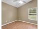 Cozy bedroom featuring laminate flooring, a ceiling fan, and a window offering natural light at 5477 Glen Oak Pl, Sanford, FL 32771