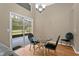 Dining area with glass table, black chairs, and sliding door access to the patio at 5477 Glen Oak Pl, Sanford, FL 32771