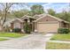 Lovely single-story home with a two-car garage and verdant front yard at 5477 Glen Oak Pl, Sanford, FL 32771