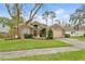 Beautiful one-story home featuring mature landscaping and a well-maintained lawn at 5477 Glen Oak Pl, Sanford, FL 32771