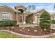 Inviting front entrance with a landscaped garden and a decorative front door at 5477 Glen Oak Pl, Sanford, FL 32771