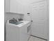 Functional laundry room equipped with a washer, dryer, and overhead cabinets for storage at 5477 Glen Oak Pl, Sanford, FL 32771