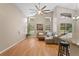 Bright living room with a high ceiling, large windows, and wood laminate flooring at 5477 Glen Oak Pl, Sanford, FL 32771