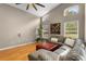 Cozy living room featuring a vaulted ceiling and wood laminate floors at 5477 Glen Oak Pl, Sanford, FL 32771