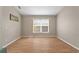 Light-filled room featuring wood laminate flooring and a bright window at 5477 Glen Oak Pl, Sanford, FL 32771