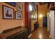 Hallway featuring art-lined walls, hardwood floors, brick accents, and stylish decor at 62 W Colonial Dr # 301, Orlando, FL 32801