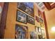 Collection of framed art pieces displayed on a textured orange wall at 62 W Colonial Dr # 301, Orlando, FL 32801