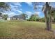 Lush backyard showcasing a screened-in pool area and ample green space at 760 Mentmore Cir, Deltona, FL 32738