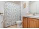 Well-maintained bathroom with a floral shower curtain and wood-finish vanity at 760 Mentmore Cir, Deltona, FL 32738