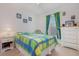 Cozy bedroom featuring a dresser, nightstand, and vibrant bedding near a window at 760 Mentmore Cir, Deltona, FL 32738