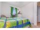 Comfortable bedroom with bright, colorful bedding and natural light from the window at 760 Mentmore Cir, Deltona, FL 32738