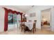 Bright dining area featuring a table for four, sliding glass doors to the pool, and adjacent bedroom view at 760 Mentmore Cir, Deltona, FL 32738