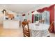 Cozy dining area with table seating, adjacent to kitchen and overlooking a screened pool at 760 Mentmore Cir, Deltona, FL 32738