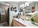 Clean bathroom featuring a single sink vanity, decorative mirror and a shower at 803 N Shore Dr, Leesburg, FL 34748