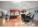 Bright dining area with wooden table and chairs adjacent to a breakfast bar and kitchen at 803 N Shore Dr, Leesburg, FL 34748