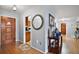 Inviting entryway showcasing wood flooring, a decorative mirror and an entrance to the kitchen at 803 N Shore Dr, Leesburg, FL 34748