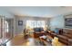 Inviting living room filled with natural light, featuring comfortable seating and wood laminate flooring at 803 N Shore Dr, Leesburg, FL 34748