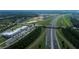 Aerial view of a community with modern buildings near a multi-lane highway and landscaped areas at 804 Pointe Emerson Blvd, Apopka, FL 32703