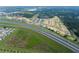 Aerial view of a planned community near a highway, showing new construction homes and green spaces at 804 Pointe Emerson Blvd, Apopka, FL 32703