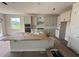 Bright kitchen featuring white cabinets, an island, and stainless steel appliances at 804 Pointe Emerson Blvd, Apopka, FL 32703