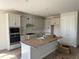 Bright kitchen with white cabinets, stainless steel appliances, and a large island at 804 Pointe Emerson Blvd, Apopka, FL 32703