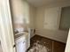 Functional laundry room featuring a sink, cabinet, and connections for a washer and dryer at 804 Pointe Emerson Blvd, Apopka, FL 32703