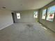 Bright, unfinished living room with three windows, neutral walls, and ample natural light at 804 Pointe Emerson Blvd, Apopka, FL 32703