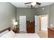 Cozy bedroom with neutral paint, ceiling fan, dresser, and access to closet; comfortable retreat at 858 Grand Regency Pt # 201, Altamonte Springs, FL 32714