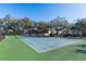 Outdoor tennis court surrounded by lush trees and greenery at 858 Grand Regency Pt # 201, Altamonte Springs, FL 32714