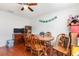 A view of the dining room featuring hardwood floors, a wood dining table and ceiling fan at 9532 Water Fern Cir, Clermont, FL 34711