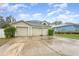 Two-story home featuring an attached three-car garage and a driveway at 9532 Water Fern Cir, Clermont, FL 34711