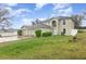 Two-story home featuring an attached three-car garage and manicured landscaping at 9532 Water Fern Cir, Clermont, FL 34711