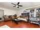 View of the living room featuring hardwood floors, ceiling fan and two couches at 9532 Water Fern Cir, Clermont, FL 34711