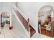 View of white staircase and dark wood stairs in a brightly lit home at 9532 Water Fern Cir, Clermont, FL 34711