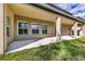 Backyard featuring a covered patio, a well-maintained lawn and the exterior walls of the house at 10024 John Adams Way, Orlando, FL 32817