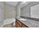 Bathroom featuring tile floors, granite countertops, and a shower-tub combo at 10024 John Adams Way, Orlando, FL 32817