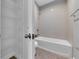 Bathroom with a shower and tub combination, complemented by open shelving for storage convenience at 10024 John Adams Way, Orlando, FL 32817