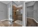 This bathroom features a walk-in shower with glass door and a view into the walk-in closet at 10024 John Adams Way, Orlando, FL 32817