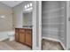 Bathroom featuring tile floors, granite countertops, and a linen closet at 10024 John Adams Way, Orlando, FL 32817